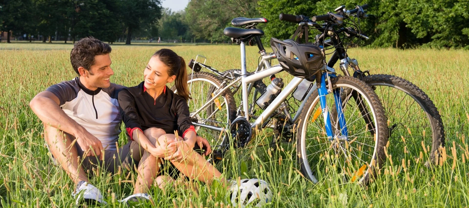 Our Favourite Cycling Tours Around Königsbrunn – Cycling Near Augsburg Starts Right Outside the Door Couple sitting on grass next to bicycles on a sunny day