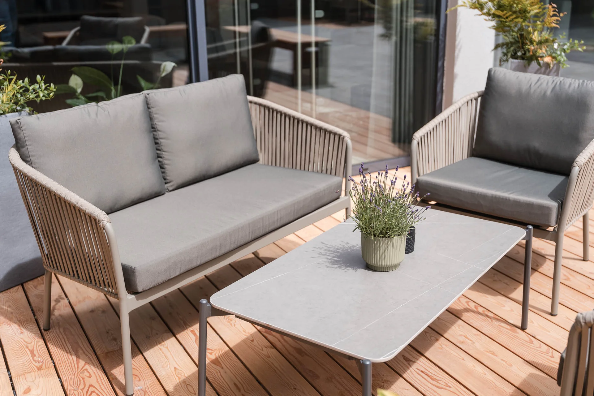 Cervus: the restaurant in Königsbrunn with special flair Moderne Sitzgruppe mit Sofa, Sessel, Tisch und Pflanze auf einer Holzterrasse im Zeller’s Quartier.