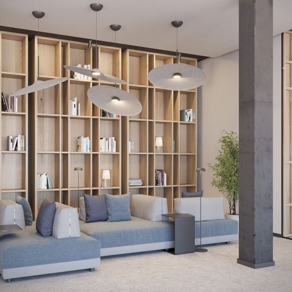 Modern waiting area with bookshelf, sofas, and hanging lights