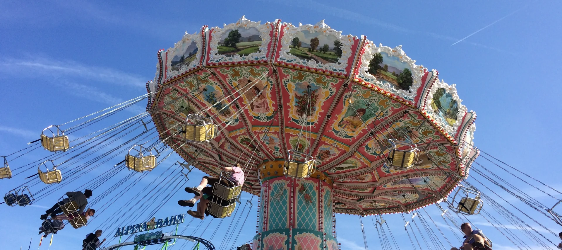 Swing ride carousel at fairground under clear blue sky